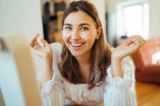 Happy woman with eye patches on face