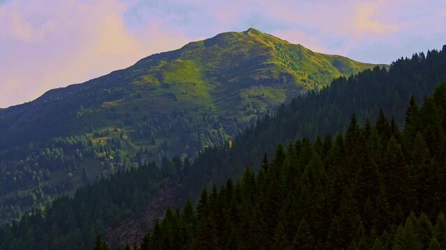 The rising sun on the Alps of Trentino Alto Adige colors the clouds and the valleys red. Brenner Pass, Trentino Alto Adige, Italy, Europe