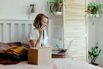Woman with gadgets getting rid of clothes