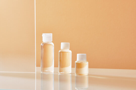 Three bottles with cork stopper on glass podium 