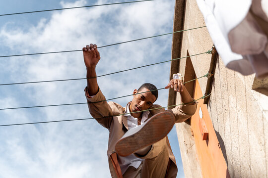 Attractive black man looking at camera on rooftop