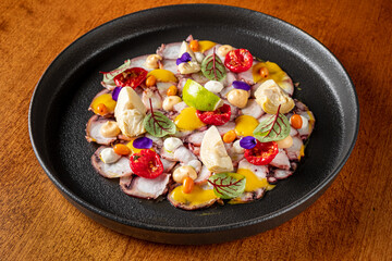 Octopus Carpaccio with sauce and vegetables