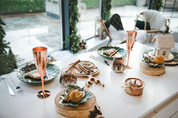 Beautiful table setting with Christmas decorations in living room. New Year. Christmas interior decoration