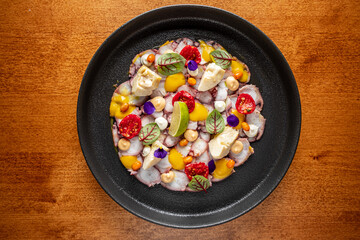 Octopus Carpaccio with sauce and vegetables