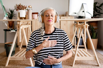 Senior woman doing relaxations at office