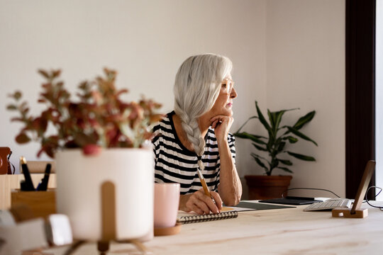 Pensive middle age woman at home office