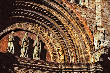 Statues illustrating theological themes on the main entrance of a church in Perugia. A city famous for its cultural agenda, in Italy. Oil paint filter