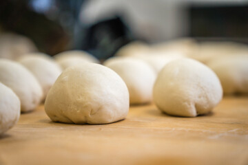 Fototapeta na wymiar making bagels - raw dough formed into shape of bagels