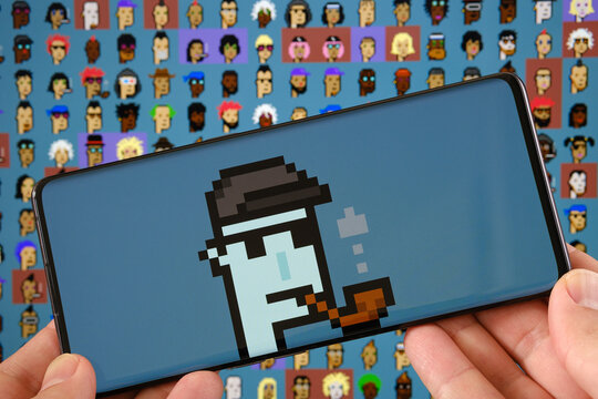 CryptoPunk #7804 NFT pixel art seen on smarphone and part of 10000 CryptoPunks collection on blurred background. Stafford, United Kingdom, October 17, 2021.