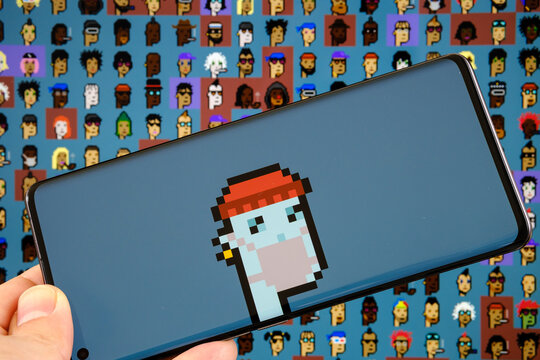 CryptoPunk #7523 NFT pixel art seen on smarphone and part of 10000 CryptoPunks collection on blurred background. Stafford, United Kingdom, October 17, 2021.