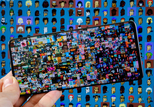 Two the most expensive NFT artworks. Concept. Beeple's "Everydays &mdash; The First 5000 Days" seen on smartphone and CryptoPunks pixel art on blurred background. Stafford, United Kingdom, October 17, 2021.