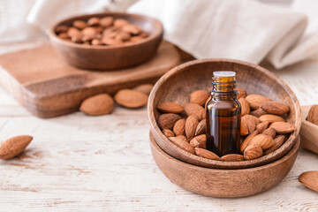 Bottle of almond essential oil on table