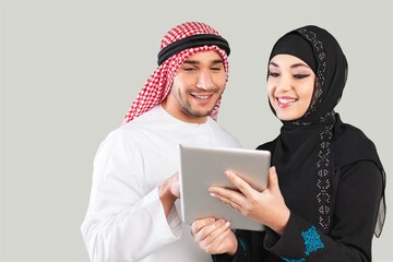 Saudi young arabian man and woman holding a digital gadget