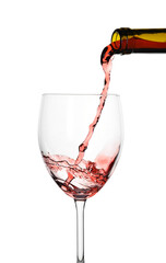 Pouring of sweet red wine into glass on white background