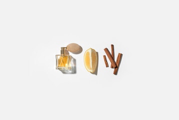Composition with bottle of elegant perfume and ingredients on white background