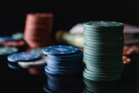 Chips for poker on dark background, closeup