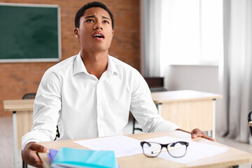 African-American student passing difficult exam at school