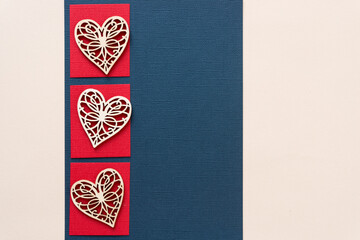 laser cut wooden heart shapes arranged on a geometric paper background