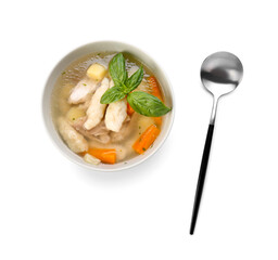 Bowl of tasty dumpling soup and spoon  on white background