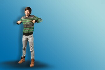Naklejka premium Full length portrait of smiling young handsome man pointing fingers