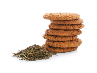 Tasty hojicha cookies and dry leaves on white background