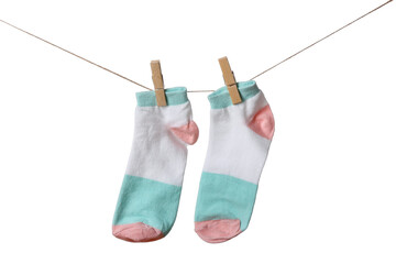 Pair of socks hanging on clothesline against white background