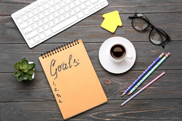 Notebook with empty to do list, computer and cup of coffee on wooden background. New year goals