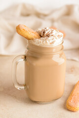 Mason jar of tasty Tiramisu Latte on table