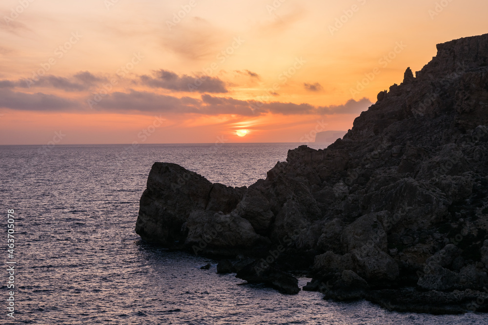 Poster Sunset on a beautiful spring day with calm sea, seen from Anchor Bay, Mellieha, Malta.