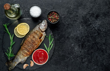 grilled trout on a stone background with copy space for your text