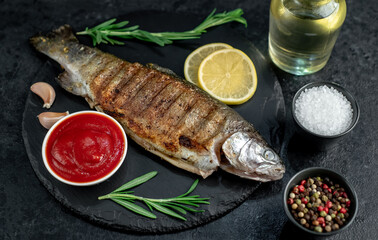 grilled trout on a stone background