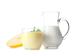 Glass and jug of tasty melon milkshake on white background