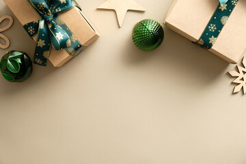 Elegant Christmas beige background with gifts, green balls, wooden decorations. Vintage style. Flat lay.
