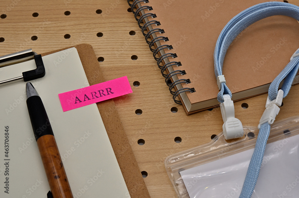 Poster there is a sticky note with the letters aarrr stamped on the edge of a clipboard placed along with a