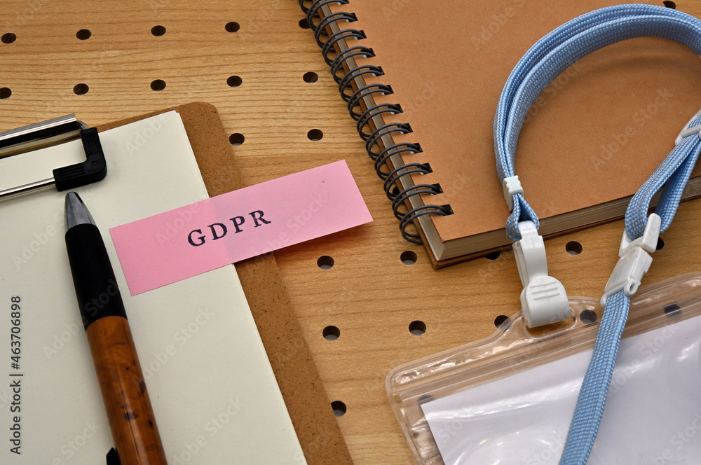 Poster there is a sticky note with the letters gdpr stamped on the edge of a clipboard placed along with a 