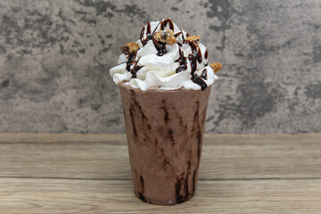Whipped cream and fudge drizzled with cookie chunks over this sweet iced drink