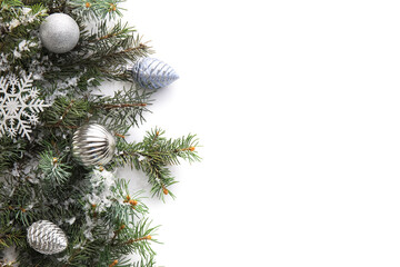Christmas composition with fir branches, decorations and snow on white background, closeup
