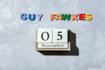 Text GUY FAWKES and calendar with date of November 5 on grunge background