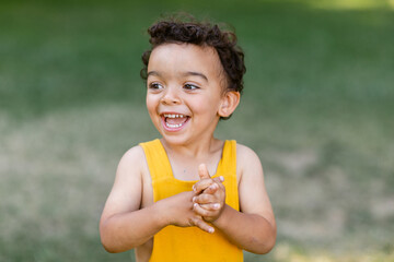 Happy boy clasping hands