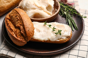 Bread with lard spread and bowl on table