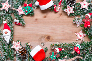 Christmas concept on a wooden background with fir branches and various Christmas toys. copy space.