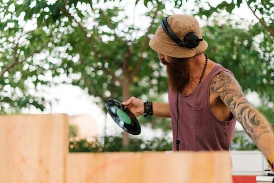 Male DJ with vinyl record in hand