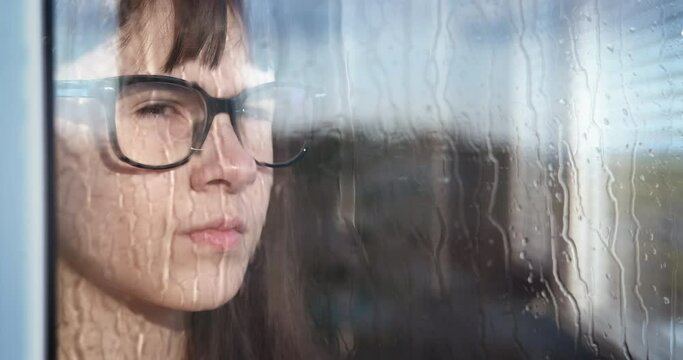 Think while rain. A sad girl think about something while rain.