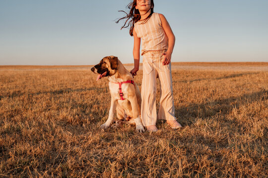 Little girl with her doggy at field