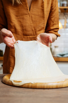 Crop woman chef making Indian flatbread at home