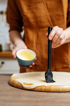 Crop woman chef making Indian flatbread at home
