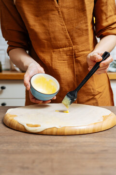 Crop woman chef making Indian flatbread at home