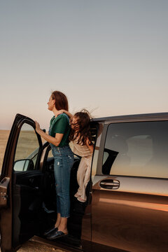 Family Looking The Sunset Inside A Van