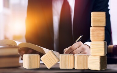 Wooden blocks with study and level up. Studying person