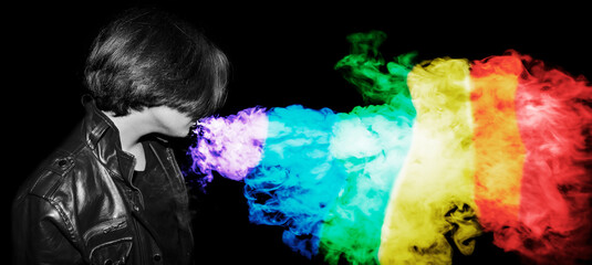 Man a leather jacket  vaping e-cigarette and blowing a rainbow cloud on black background